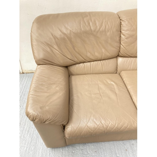 794 - A modern brown leather three seater sofa