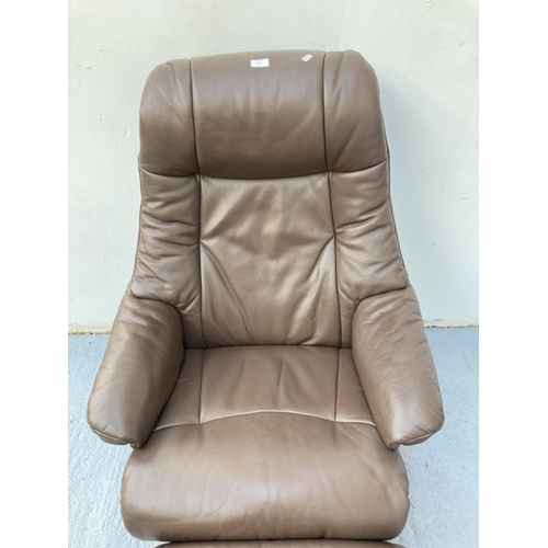 797 - A Stressless style brown leather swivel armchair with matching footstool