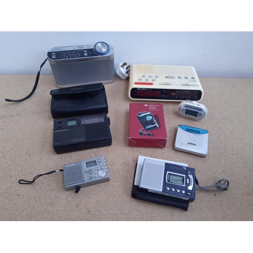 1015 - A box containing radios to include Roberts New Classic 993 three band, cased Grundig Traveller II se... 