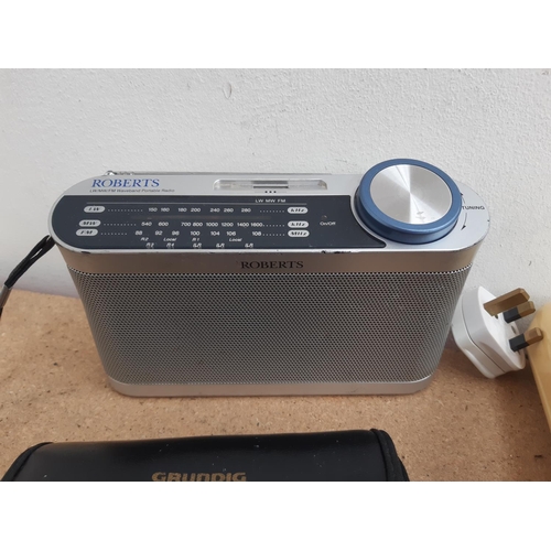 1015 - A box containing radios to include Roberts New Classic 993 three band, cased Grundig Traveller II se... 