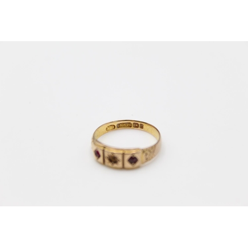 65 - A 15ct gold garnet set gypsy ring, size M - approx. gross weight 2.3 grams