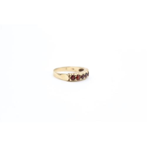 74 - A 9ct gold garnet set half eternity ring, size O - approx. gross weight 2.7 grams