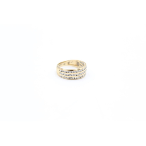 90 - A 9ct gold channel set CZ three row band ring, size J - approx. gross weight 2.3 grams
