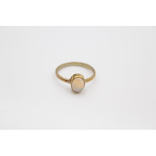 101 - A hallmarked Birmingham 9ct gold opal solitaire in rubover set ring - approx. gross weight 1.9 grams... 