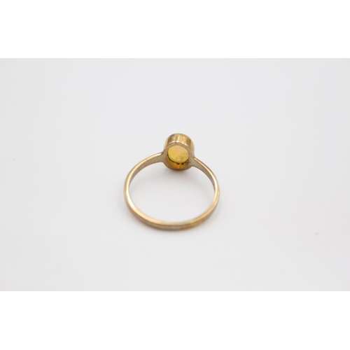 101 - A hallmarked Birmingham 9ct gold opal solitaire in rubover set ring - approx. gross weight 1.9 grams... 