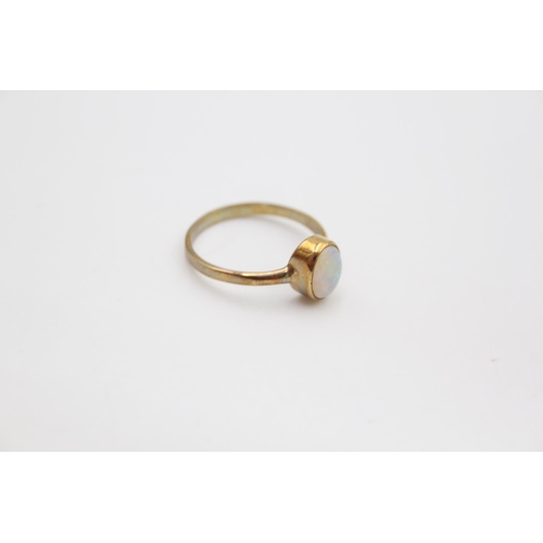 101 - A hallmarked Birmingham 9ct gold opal solitaire in rubover set ring - approx. gross weight 1.9 grams... 