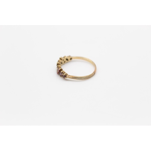 142 - A hallmarked Birmingham 9ct gold garnet band stacking ring, size Q - approx. gross weight 1.5 grams