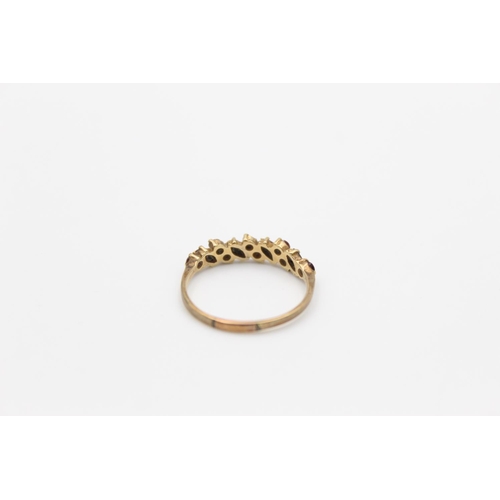 142 - A hallmarked Birmingham 9ct gold garnet band stacking ring, size Q - approx. gross weight 1.5 grams