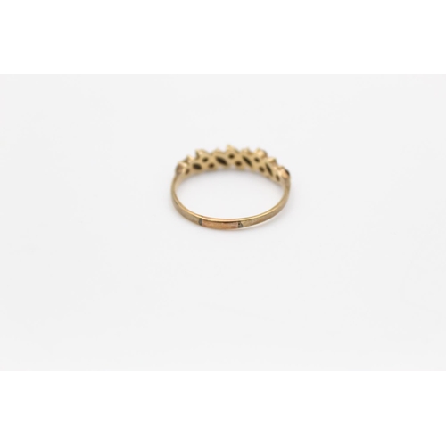 142 - A hallmarked Birmingham 9ct gold garnet band stacking ring, size Q - approx. gross weight 1.5 grams