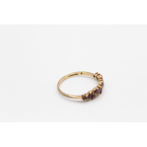 142 - A hallmarked Birmingham 9ct gold garnet band stacking ring, size Q - approx. gross weight 1.5 grams