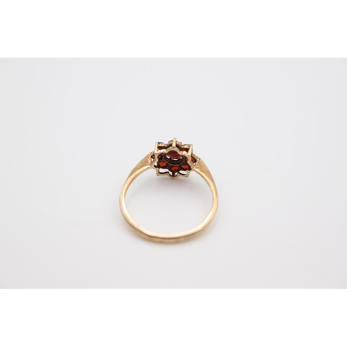 166 - A hallmarked Birmingham 9ct gold garnet cluster ring, size P - approx. gross weight 1.6 grams