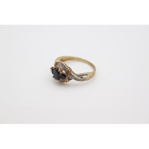 180 - A hallmarked Birmingham 9ct gold sapphire and diamond ring, size O - approx. gross weight 2.6 grams