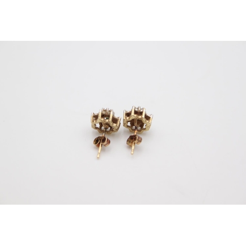 182 - A pair of hallmarked Birmingham 9ct gold diamond and emerald cluster stud earrings - approx gross we... 