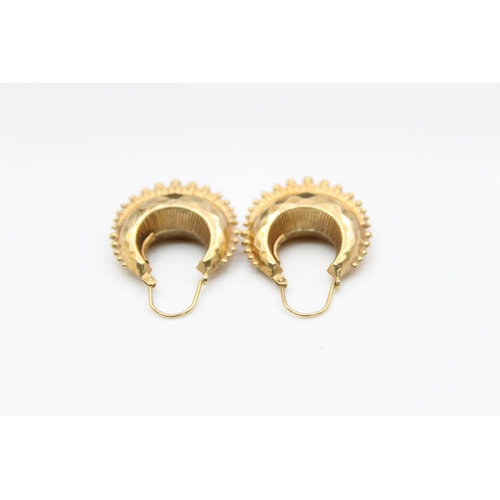 184 - A pair of 9ct gold facetted hoop earrings - approx. gross weight 3.2 grams