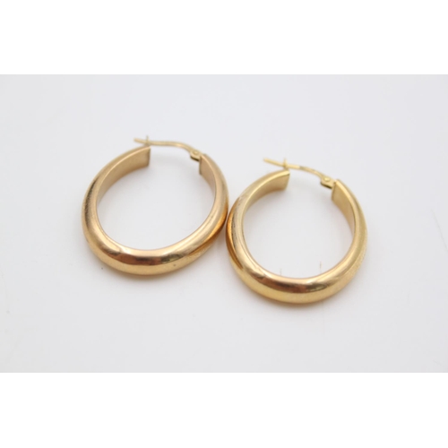 222 - A pair of 9ct gold oval hoop earrings - approx. gross weight 2.6 grams