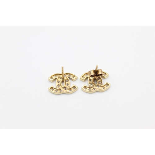 186 - A pair of 9ct gold CZ set CC studs - approx. gross weight 2.6 grams