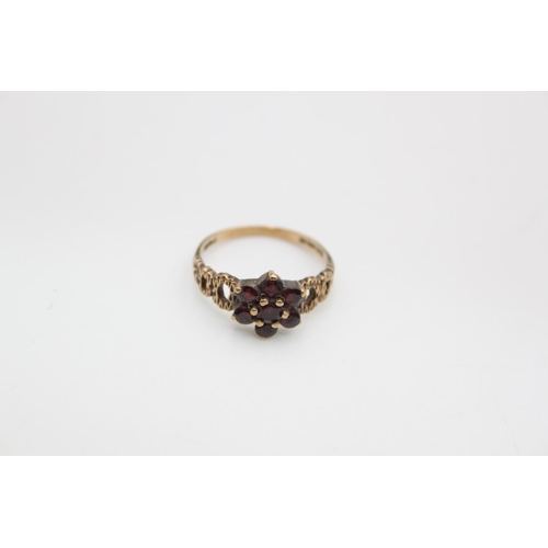 104 - A hallmarked London 9ct gold garnet flower ring, size N - approx. gross weight 2.2 grams