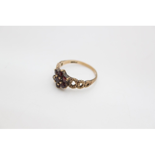 104 - A hallmarked London 9ct gold garnet flower ring, size N - approx. gross weight 2.2 grams