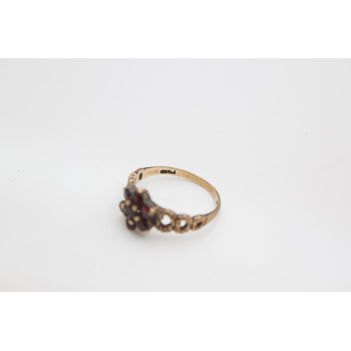 104 - A hallmarked London 9ct gold garnet flower ring, size N - approx. gross weight 2.2 grams