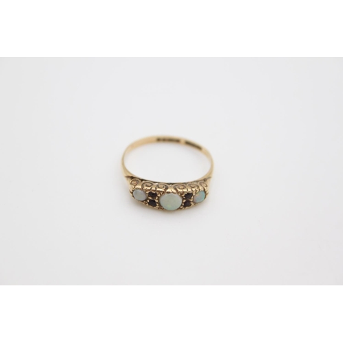 175 - A 9ct gold opal and garnet set dress ring, size P - approx. gross weight 2.1 grams