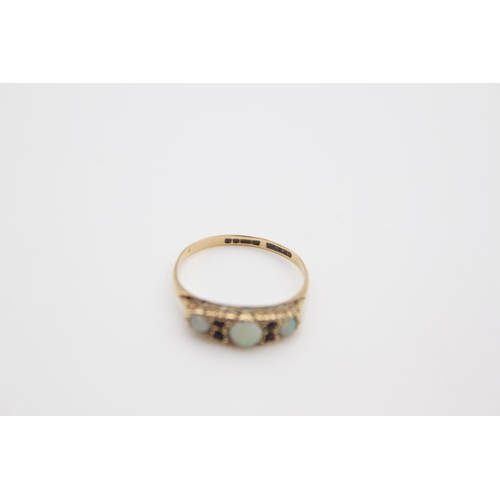 175 - A 9ct gold opal and garnet set dress ring, size P - approx. gross weight 2.1 grams