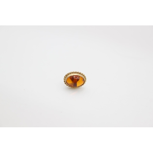 209 - A pair of 9ct gold amber stud earrings - approx. gross weight 0.9 grams