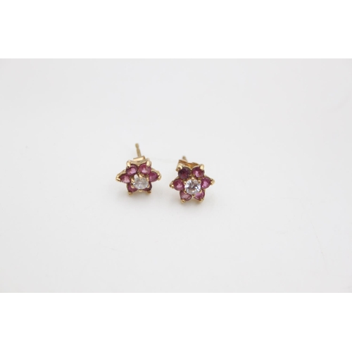 215 - A pair of 9ct gold red and white gemstone set cluster stud earrings - approx. gross weight 1.2 grams