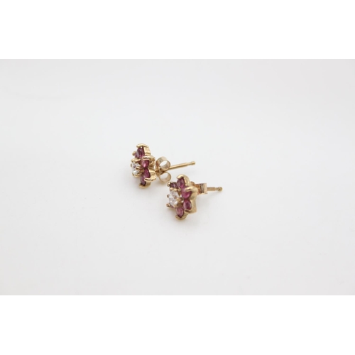 215 - A pair of 9ct gold red and white gemstone set cluster stud earrings - approx. gross weight 1.2 grams