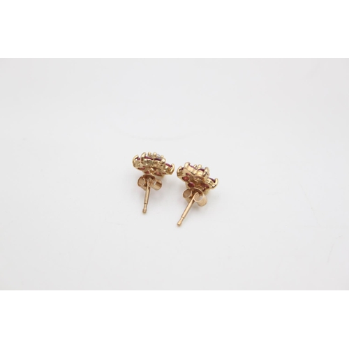 215 - A pair of 9ct gold red and white gemstone set cluster stud earrings - approx. gross weight 1.2 grams