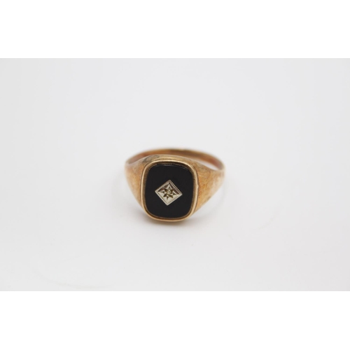 61 - A hallmarked Birmingham 9ct gold onyx and diamond signet ring, size W - approx. gross weight 3.1 gra... 