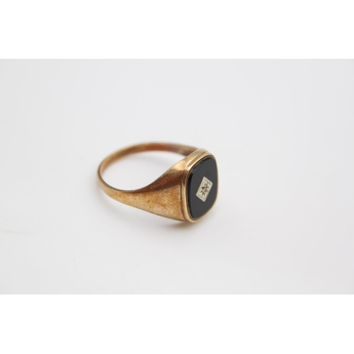 61 - A hallmarked Birmingham 9ct gold onyx and diamond signet ring, size W - approx. gross weight 3.1 gra... 