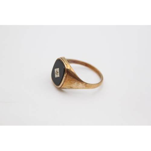 61 - A hallmarked Birmingham 9ct gold onyx and diamond signet ring, size W - approx. gross weight 3.1 gra... 