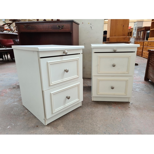 1091 - A pair of white laminate bedside chests of two drawers -  approx. 60cm high x 42cm wide x 50cm deep