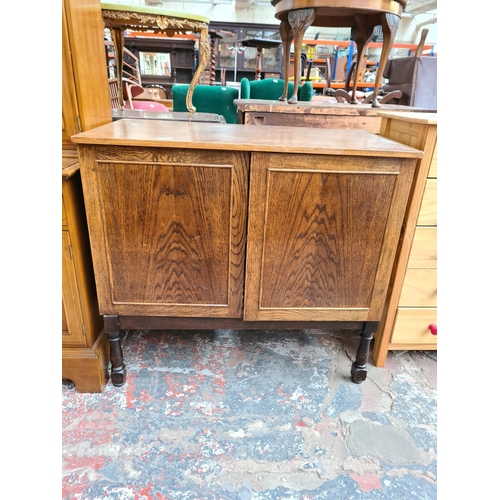 1097 - A vintage oak media cabinet with two doors and later added stand - approx. 86cm high x 94cm wide x 5... 