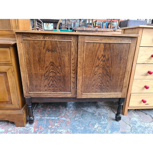 1097 - A vintage oak media cabinet with two doors and later added stand - approx. 86cm high x 94cm wide x 5... 