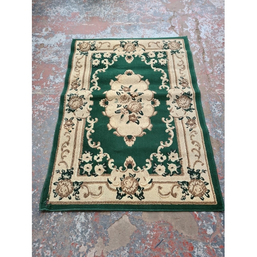 1098 - A late 20th century Moroccan green and ivory rug - approx. 120cm wide x 170cm long