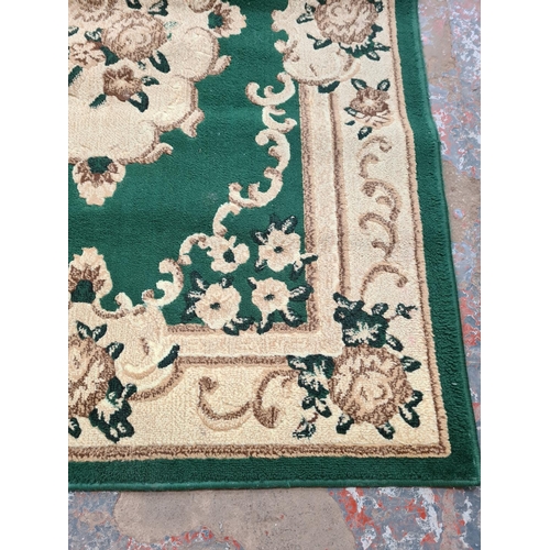 1098 - A late 20th century Moroccan green and ivory rug - approx. 120cm wide x 170cm long