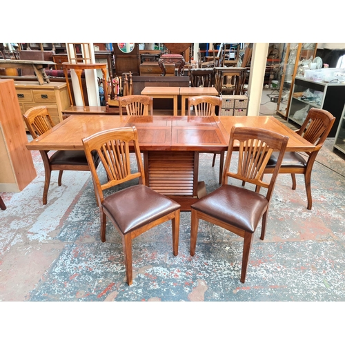 1108 - A Starbay Amiral rosewood veneer louvered pedestal extending dining table with two extension leaves,... 