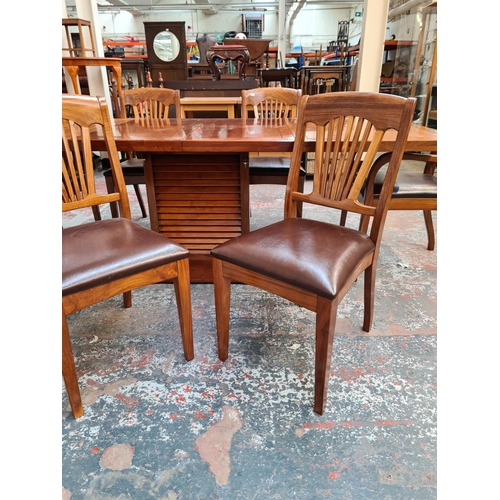 1108 - A Starbay Amiral rosewood veneer louvered pedestal extending dining table with two extension leaves,... 