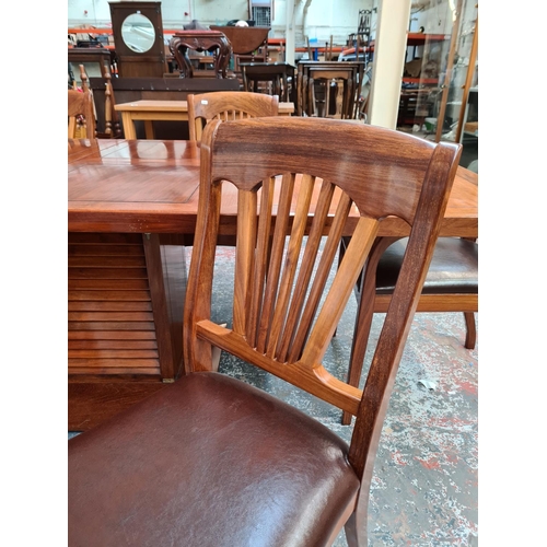 1108 - A Starbay Amiral rosewood veneer louvered pedestal extending dining table with two extension leaves,... 