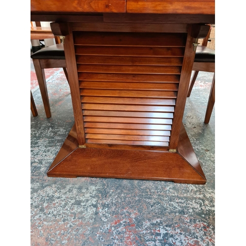 1108 - A Starbay Amiral rosewood veneer louvered pedestal extending dining table with two extension leaves,... 