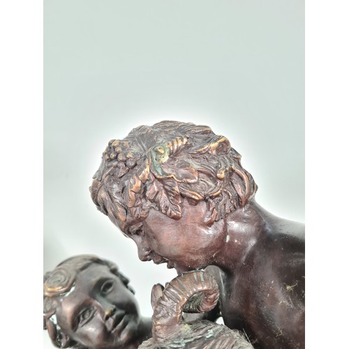 458 - A pair of mid 20th century French school bronze sculptures with bacchic putti fawning over sacrifici... 