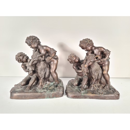 458 - A pair of mid 20th century French school bronze sculptures with bacchic putti fawning over sacrifici... 