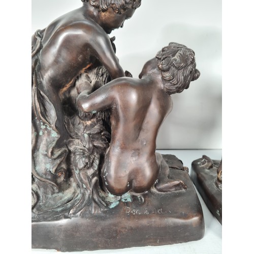 458 - A pair of mid 20th century French school bronze sculptures with bacchic putti fawning over sacrifici... 