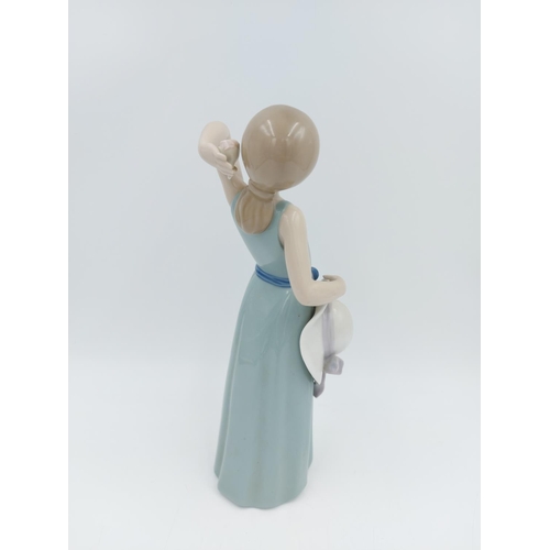 464 - A Lladro Prissy Coiffure Girl With Hat figurine, ref no. 5010 - approx. 24cm high