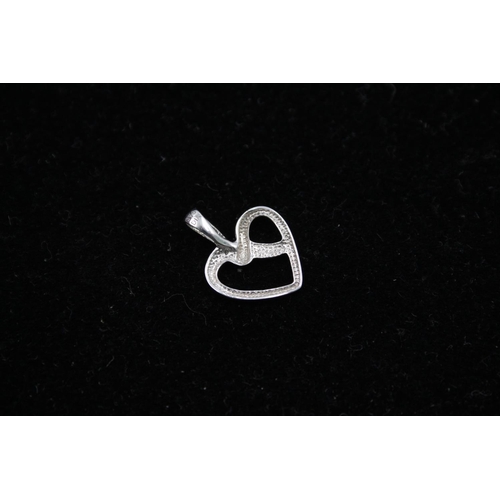 140 - Two 9ct white gold heart pendants to include one diamond - approx. gross weight 1.4 grams