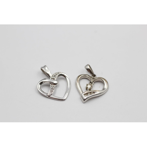 140 - Two 9ct white gold heart pendants to include one diamond - approx. gross weight 1.4 grams