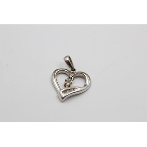 140 - Two 9ct white gold heart pendants to include one diamond - approx. gross weight 1.4 grams