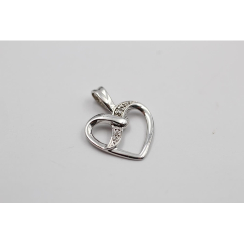 140 - Two 9ct white gold heart pendants to include one diamond - approx. gross weight 1.4 grams