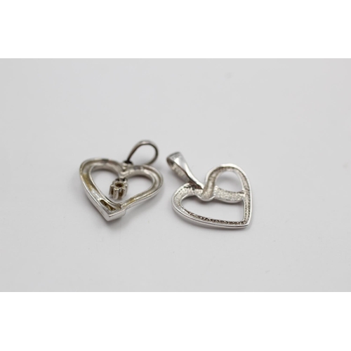 140 - Two 9ct white gold heart pendants to include one diamond - approx. gross weight 1.4 grams